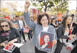  ?? Al Seib Los Angeles Times ?? A DEPUTY public defender holds a poster of Interim Public Defender Nicole Davis Tinkham at a protest in February. Ricardo Garcia will replace Tinkham.