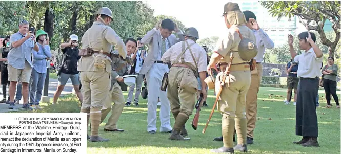  ?? PhotograPh by Joey sanChez Mendoza for the daily tribune@tribunephl_joey ?? MeMbers of the Wartime heritage guild, clad in Japanese imperial army uniform, reenact the declaratio­n of Manila as an open city during the 1941 Japanese invasion, at fort santiago in intramuros, Manila on sunday.
