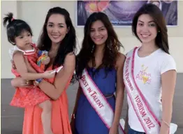  ??  ?? Bea Rose Santiago, Mary Yasol and Rizzini Alexis Gomez with
one of the children at Asilo dela Milagrosa.