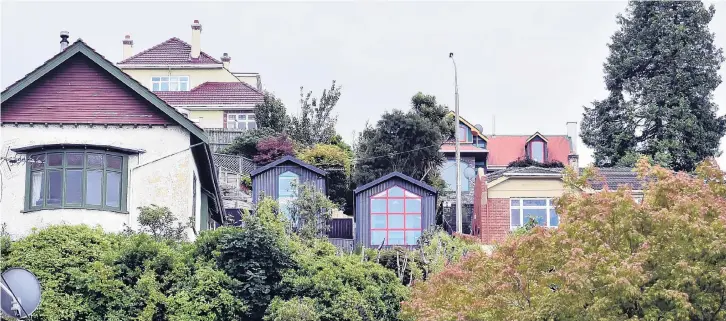  ?? PHOTOS: PETER MCINTOSH, SARAH COPELAND ?? The houses were deliberate­ly lined up with neighbouri­ng ones so they would not dominate the rest of the street.