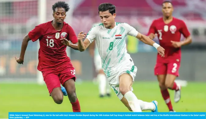  ?? — AFP ?? DOHA: Qatar’s forward Yusuf Abdurisag (L) vies for the ball with Iraq’s forward Ibrahim Bayesh during the 24th Arabian Gulf Cup Group A football match between Qatar and Iraq at the Khalifa Internatio­nal Stadium in the Qatari capital Doha yesterday.