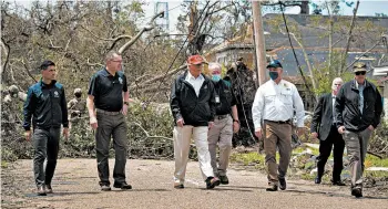  ?? AL DRAGO/THE NEW YORK TIMES ?? President Trump tours storm damage with state and federal officials Saturday in Lake Charles, La. He also visited Texas.
