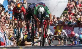  ?? 16. Photograph: Angel Fernandez/AP ?? Primoz Roglic falls after a collision with Fred Wright (left, in red) close to the end of stage