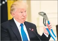  ?? Getty Images ?? President Donald Trump holds up a pair of pliers as he speaks during a Made in America event with U.S. manufactur­ers in the East Room of the White House last year.