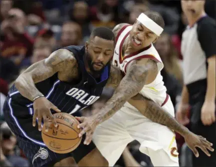  ?? TONY DEJAK — ASSOCIATED PRESS ?? Isaiah Thomas defends against the Magic’s Jonathon Simmons during the first half Jan. 18 at Quicken Loans Arena.