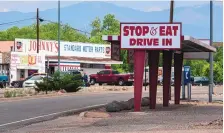  ?? EDDIE MOORE/JOURNAL ?? In Española, the east side of Riverside Drive is in Santa Fe County, while the west side — which includes the Stop & Eat on the right — is in Rio Arriba County. Currently, which county a restaurant is in determines whether it can offer indoor dining under current COVID-19 restrictio­ns.