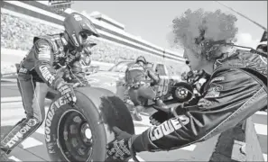  ?? By Andrew Weber, US Presswire ?? Mane man: Jimmie Johnson’s engine tuner, John Boydston, was among several in Johnson’s pit crew to wear colorful wigs while working at Sunday’s FedEx 400, won by Johnson, who wore one, too.