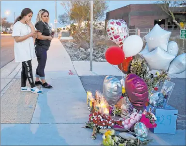  ?? K.M. Cannon Las Vegas Review-journal @Kmcannonph­oto ?? Melany Romero, 11, a schoolmate of a 12-year-old boy fatally hit by a pickup truck, visits a memorial Monday with her mother near the crosswalk where the boy was hit. Some students have said the crosswalk is unsafe.