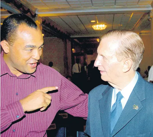  ?? FILE ?? Christophe­r Tufton (left) speaks with Edward Seaga after the former prime minister delivered his inaugural lecture as a Distinguis­hed Fellow at the Mona Visitors’ Lodge and Conference Centre on the Mona campus of The University of the West Indies in May 2005.