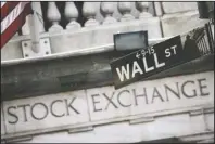  ?? The Associated Press ?? WORST QUARTER: A street sign for Wall Street outside the New York Stock Exchange in New York on July 16, 2013.