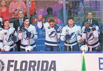  ?? WILFREDO LEE, AP ?? Lightning right wing J.T. Brown raised his fist during the singing of the national anthem before the start of the game Saturday.