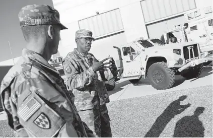  ?? LLOYD FOX/BALTIMORE SUN PHOTOS ?? Col. Morris L. Bodrick, commander of the Army’s Aberdeen Test Center, talks about the advantages of the new Joint Light Tactical Vehicle behind him. The vehicle is designed to be faster, more secure and smoother-riding than the Humvee.