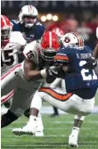  ?? GEORGIA PHOTO BY PERRY MCINTYRE JR. ?? Georgia outside linebacker D’Andre Walker (15) stops Auburn running back Kerryon Johnson during last December’s SEC title game at Mercedes-Benz Stadium in Atlanta.