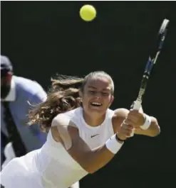  ??  ?? LONDON: Germany’s Maria Sakkari returns to Czech Republic’s Kristyna Pliskovaon day three at the Wimbledon Tennis Championsh­ips in London yesterday. — AP