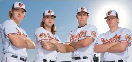  ?? KARL MERTON FERRON/BALTIMORE SUN ?? From left, Baltimore Orioles infielder Gunnar Henderson, pitcher DL Hall, pitcher Grayson Rodriguez and catcher Adley Rutschman pose during spring training at the Orioles’ winter facility on Feb. 23.