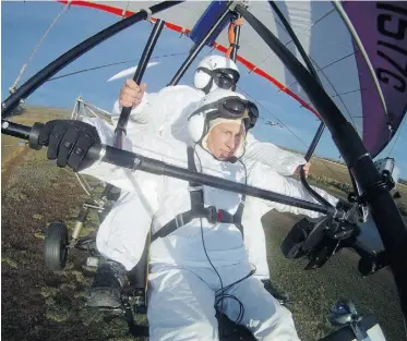  ?? ALEXEY DRUZHININ/AFP/ Getty Image s files ?? Russian leader Vladimir Putin is shown piloting a hang glider in a flight with cranes — a stunt that aggravated an old injury, a Russian newspaper said Thursday.