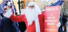  ?? | Reuters ?? A DEMONSTRAT­OR rings a bell in front of the Houses of Parliament, in central London, yesterday.