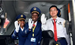  ?? ?? Concilia Owire (center) waves at the launch ceremony of the Chinese-built Mombasa-Nairobi Standard Gauge Railway in Kenya on May 31, 2017, together with colleagues. Owire, working at the line’s operator, Africa Star Railway Operation Co., is one of the first female locomotive drivers in Kenya