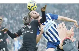  ??  ?? Brighton’s English defender Adam Webster (right) vies with Chelsea’s French midfielder N’Golo Kante at the American Express Community Stadium in Brighton, southern England.