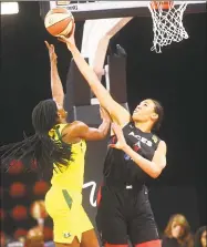  ?? Chase Stevens / Associated Press ?? The Las Vegas Aces’ Liz Cambage, right, blocks a shot from the Seattle Storm’s Crystal Langhorne during the first half of a WNBA game last month.