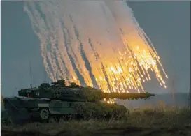  ?? ?? The Associated Press
A Germany army main battle tank Leopard 2A6 takes part in the NATO military exercise ‘Iron Wolf 2022-II’ at a training range in Pabrade, north of Vilnius, Lithuania.