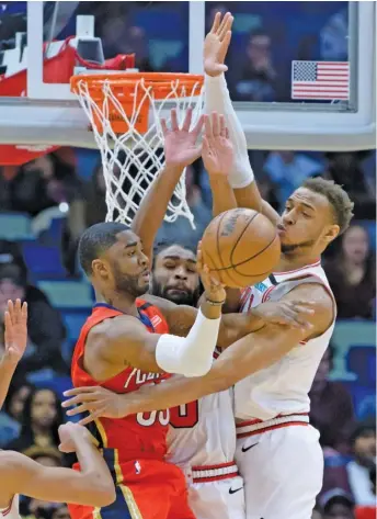  ?? MATTHEW HINTON/AP ?? Pelicans guard E’Twaun Moore, a former Bull, battles with Bulls rookie guard Coby White, who had 10 points, and rookie big man Daniel Gafford in the first half Wednesday night.