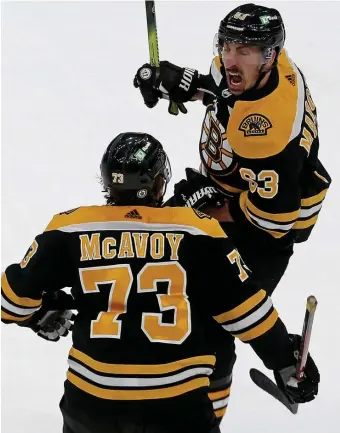  ?? MATT sTONE / hErAld sTAff filE ?? HIGH HOPES: Despite plenty of turnover this offseason, Bruins forward Brad Marchand, seen here with Charlie McAvoy during a May 31 playoff tilt against the Islanders, is excited for the upcoming season.
