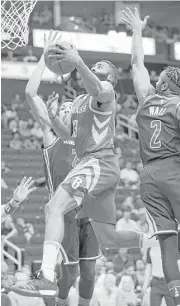  ?? Elizabeth Conley / Houston Chronicle ?? Rockets guard James Harden splits two Wizards defenders, including All-Star guard John Wall, during the first half Tuesday night.