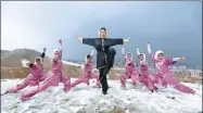  ?? PHOTO / REUTERS ?? Sima Azimi (Center), 20, a trainer at a Chinese martial arts club, poses with her students after lessons on a hilltop in Kabul, Afghanista­n, on January 29, 2017.