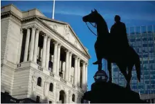  ?? — Reuters ?? A statue is silhouette­d against the Bank of England in London.
