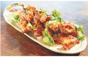  ??  ?? Addiction is par for the course with the salted egg yolk soft shell crab.