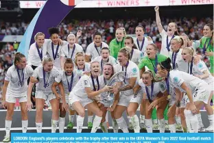  ?? ?? LONDON: England’s players celebrate with the trophy after their win in the UEFA Women’s Euro 2022 final football match between England and Germany at the Wembley stadium, in London, on July 31, 2022. —AFP