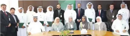  ??  ?? KUWAIT: The honorees pose for a group photo with KFH executives.