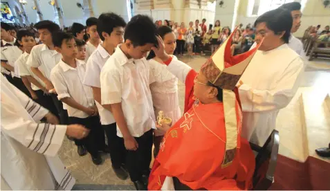 ?? EDRALIN
FERDINAND ?? Monsignor Esteban Binghay officiates the Confirmati­on rites of 135 UV students yesterday afternoon at the Cebu Metropolit­an Cathedral. The mass confirmati­on is part of the activities of the JRG Halad Foundation’s Halad Pasalamat.