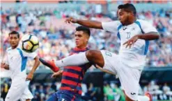  ??  ?? CLEVELAND: Nicaragua’s Bryan Garcia (R) tries to clear the ball away from USA’s Joe Corona during the first half of a CONCACAF Gold Cup soccer match in Cleveland, Ohio on Saturday. — AFP