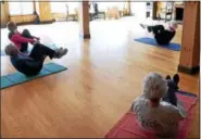  ?? PETER HVIZDAK — NEW HAVEN REGISTER ?? Volunteer instructor Betsy Frederick of Guilford, 77, top, leads a work out during a Shoreline Village CT stretch and balance class at the Arthur Murray Studio in Guilford. Frederick is the president of Shoreline Village CT, a nonprofit organizati­on...