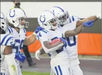  ?? DAVID RICHARD - THE ASSOCIATED PRESS ?? Indianapol­is Colts cornerback Isaiah Rodgers (34) celebrates with teammates after Rodgers returned a kickoff for 101yard touchdown during the second half of an NFL football game against the Cleveland Browns, Sunday, Oct. 11, 2020, in Cleveland.