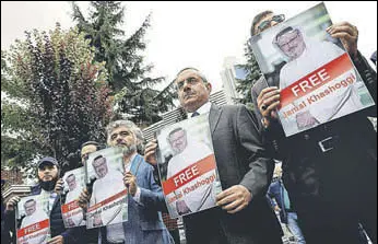  ?? REUTERS ?? Human rights activists and friends of Saudi journalist Jamal Khashoggi hold his pictures during a protest outside the Saudi consulate in Istanbul, Turkey, earlier this week.