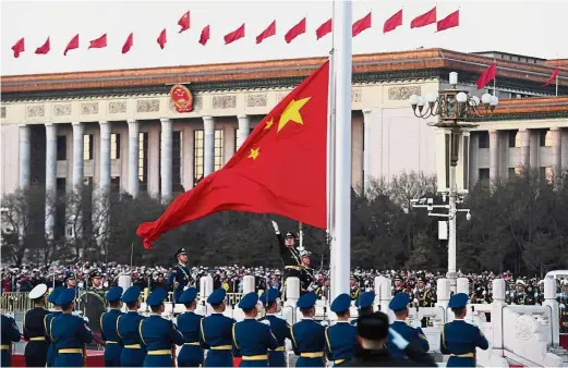  ?? — Xinhua ?? Rising to the occasion: The Guard of Honour of the PLA performing the national flagraisin­g duty at the Tiananmen Square in Beijing.