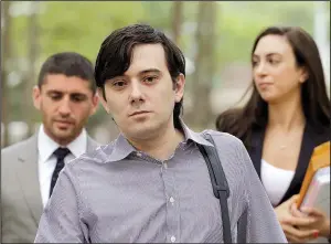  ?? AP/MARK LENNIHAN ?? Martin Shkreli (center) arrives at Brooklyn federal court with members of his legal team on June 19 in New York for a pretrial conference in his securities fraud trial.