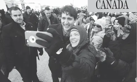  ?? JOHN WOODS / THE CANADIAN PRESS ?? Prime Minister Justin Trudeau greets a crowd after announcing the opening of a repaired railway in Churchill, Man., on Thursday.