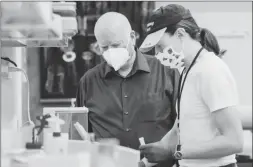  ?? ?? Dr. Robert Sutherland, shown on the left, and his lab will determine the dose range of active ingredient­s that will be used in human trials and will identify potential side effects.