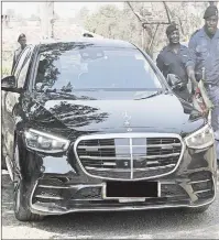  ?? (Pics: Mthunzi Mdluli) ?? The PM being escorted as he arrives at the police photograph­y and printing centre yesterday. (L) The PM wearing sunglasses yesterday as he visited the Royal Eswatini Police Service’s designated operationa­l pipelines, such as the new camp in Mbabane.