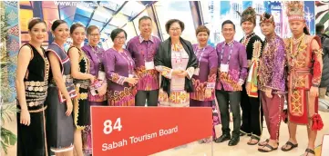  ??  ?? Christina (centre), flanked by Pan and Suzaini, with the STB delegation and cultural troupe from the Sabah Cultural Board.