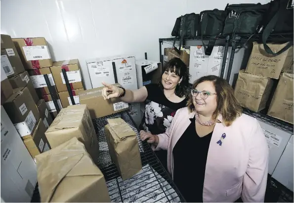  ?? DAVID BLOOM ?? Melanie Mathers-Mah, associate manager of the immunizati­on program for Northern Alberta, left, and Health Minister Sarah Hoffman tour the Alberta Health Services vaccine depot at the Edmonton General Continuing Care Centre on Monday.