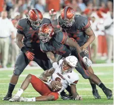  ?? THOMAS B. SHEA, GETTY IMAGES ?? Quarterbac­k Lamar Jackson was sacked 11 times in Louisville’s loss to Houston last week.