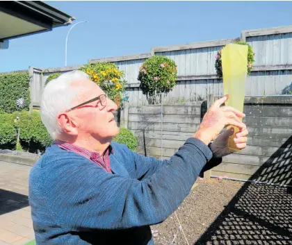  ?? Photo / Milly Fullick ?? Bevan Choat checks his rain gauge after another wet start to the week in Taupō .