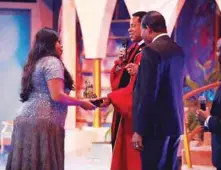  ??  ?? Gospel Music Diva Sinach receiving the highest LIMA Award 2019 Song Of the Year for her Song “There’s an Overflow” from President Loveworld Incorporat­ed Rev Dr Chris Oyakhilome at the Biggest Gospel Music and Arts Awards in Lagos Sunday night