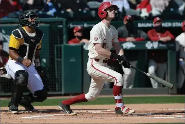  ?? (NWA Democrat-Gazette/Andy Shupe) ?? Matt Goodheart of Arkansas and Arkansas-Pine Bluff catcher Jackson Rehkow watch the flight of Goodheart’s leadoff home run in the first inning of the Razorbacks’ victory over the Golden Lions on Wednesday at Baum-Walker Stadium in Fayettevil­le. Goodheart had two of the Hogs’ eight home runs. More photos available at arkansason­line.com/415basebal­l.