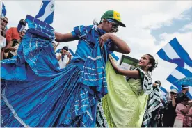  ?? CRISTOBAL VENEGAS THE ASSOCIATED PRESS ?? Anti-government demonstrat­ors in folkloric dresses dance during a march in Managua on Saturday demanding the ouster of Daniel Ortega and the release of political prisoners.